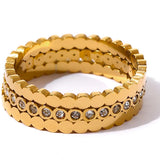 Gold ring with embedded stones on a white background