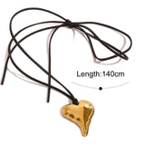 Gold heart-shaped pendant on a black cord with length measurement on a white background