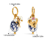 Pair of earrings with gold accents and ceramic elements, shown with measurements on a white background.