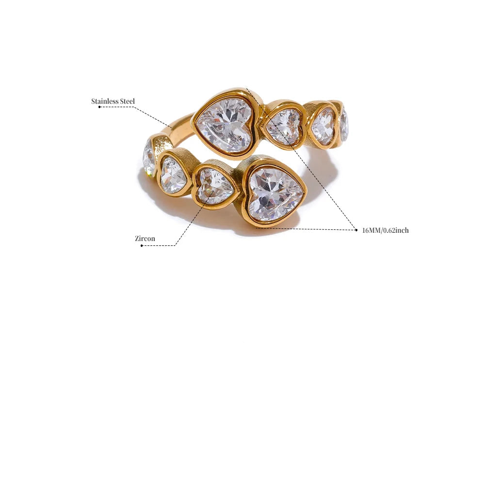 Gold ring with heart-shaped gemstones on a white background