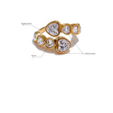 Gold ring with heart-shaped gemstones on a white background