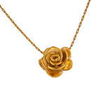 Gold rose-shaped pendant on a chain against a white background