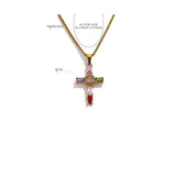 Gold cross pendant necklace with colored stones on a white background