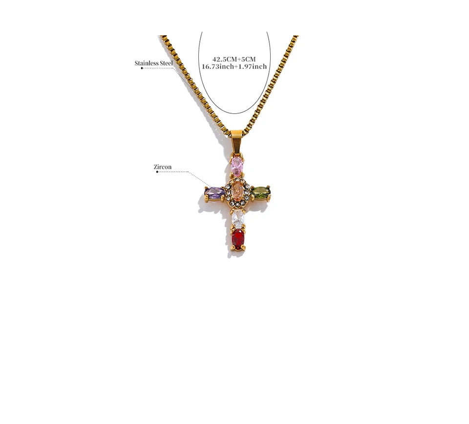 Gold cross pendant necklace with colored stones on a white background