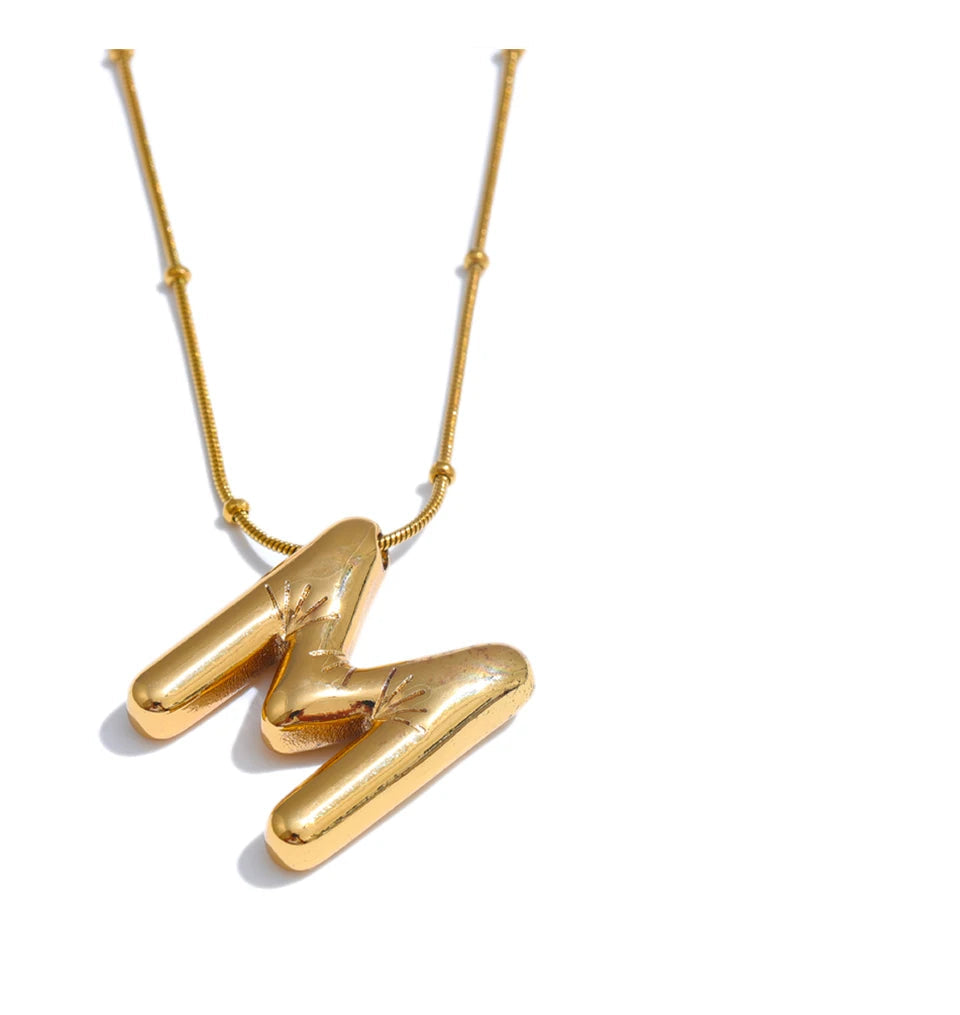 Gold necklace with a unique pendant on a white background