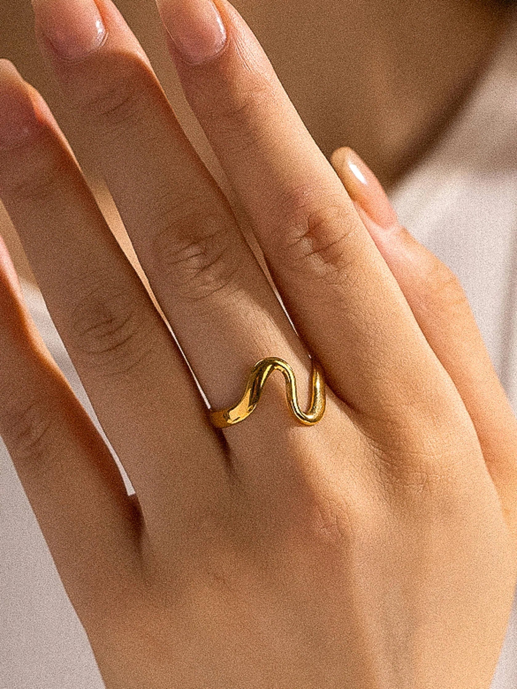 Elegant Adjustable Gold Plated Wave Ring, 18K gold-plated with a smooth, wavy design, perfect for everyday wear and special occasions.
