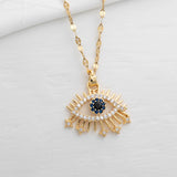 Elegant gold chain necklace featuring ancient Egyptian eye symbol with zirconia detailing