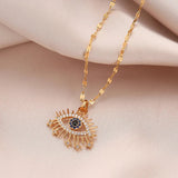 Gold Egyptian necklace featuring an evil eye pendant with cubic zirconia for protection and spiritual symbolism