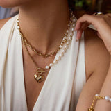 Elegant freshwater pearl heart necklace with gold chain, perfect for adding a romantic touch to any outfit