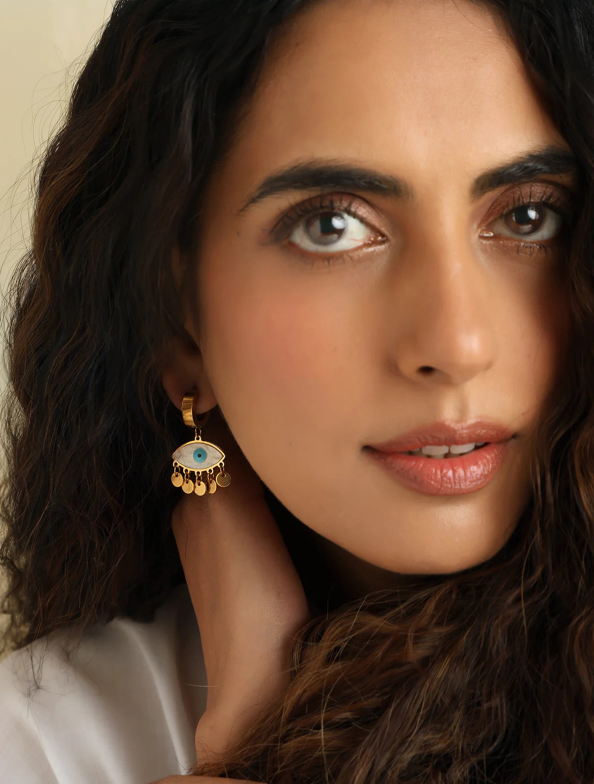 Gold stainless steel evil eye drop earrings with shell charm and blue enamel for everyday boho style and protection.