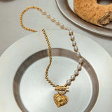 Gold heart pendant necklace featuring a lustrous freshwater pearl, ideal for modern yet timeless everyday wear