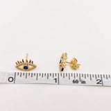 Stylish gold-plated evil eye stud earrings with blue center and cubic zirconia stones, polished lashes design, ideal for layering or solo wear.