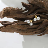 Gold-plated round pearl earrings featuring soft freshwater pearls in a trio design for classic everyday charm