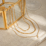 Beautiful Gold Triple Chain Natural Pearl Necklace with delicate chains and a pearl drop, perfect for adding elegance to everyday or dressy outfits.