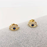 Golden evil eye stud earrings with deep blue center and sparkling cubic zirconia, 18k gold plated on stainless steel, stylish protective everyday jewelry.
