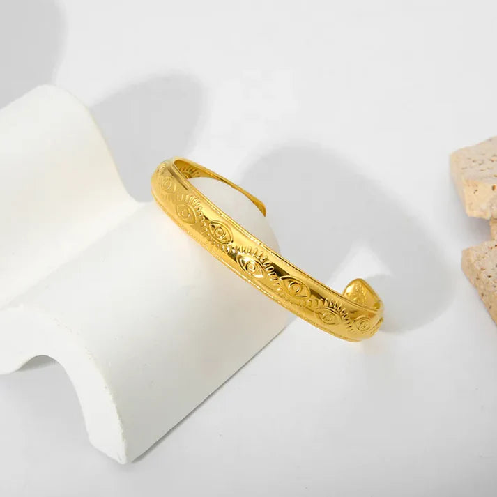 Elegant Lady's Evil Eye Cuff Bracelet, 18K gold-plated with an eye-catching design, combining protection and sophistication for any outfit.