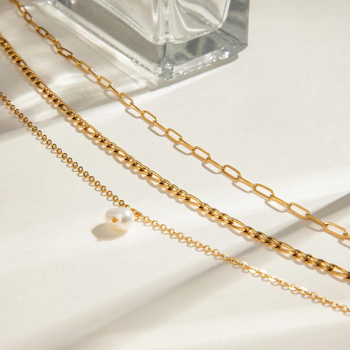 Elegant Layered Triple Chain Natural Pearl Necklace, 18K gold-plated with a pearl drop, perfect for adding a refined touch to any outfit.