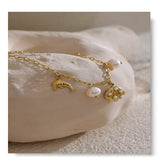 18k gold plated bracelet with pearl, dolphin, and shell charms on stainless steel chain, waterproof and adjustable.