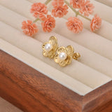 Radiant pearl stud earrings with shiny gold flower petals and a luxe oversized design