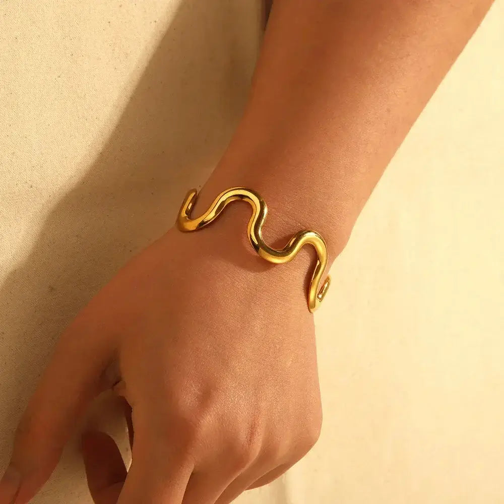 Modern wave-shaped gold cuff bracelet with flexible stainless steel wire, waterproof and tarnish-free for stylish everyday wear