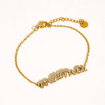 Gold bracelet with a chain design on a white background