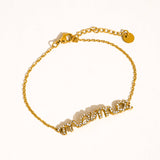 Gold bracelet with a chain design on a white background