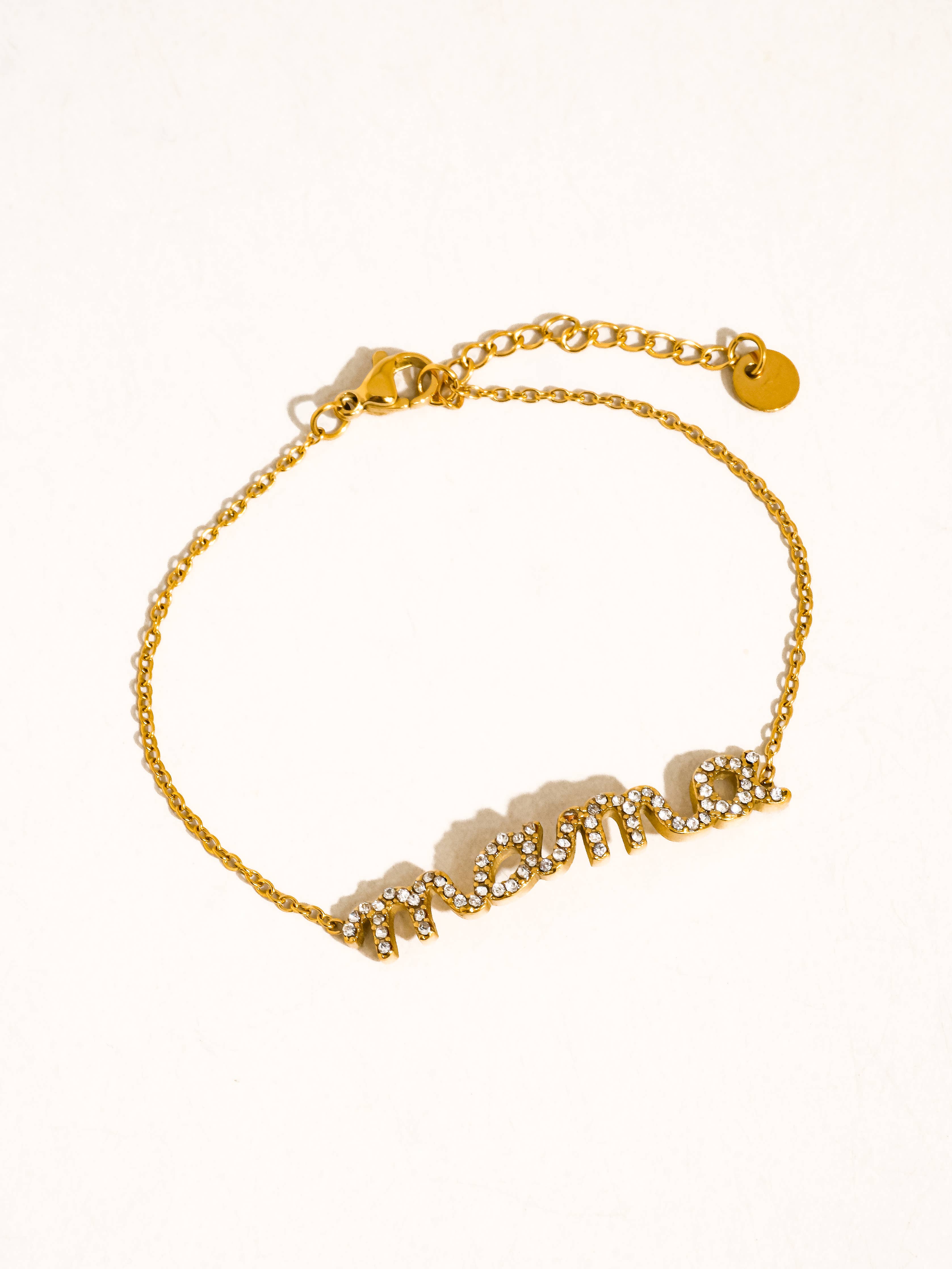 Gold bracelet with a chain design on a white background