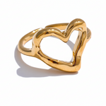 Gold heart-shaped ring on a white background