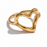 Gold heart-shaped ring on a white background