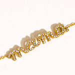 Gold bracelet with 'Amour' text on a white background