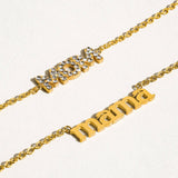 Two gold necklaces with 'mom' and 'mama' on a white background