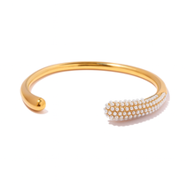 Gold-plated bangle with delicate pearl accents and stainless steel base