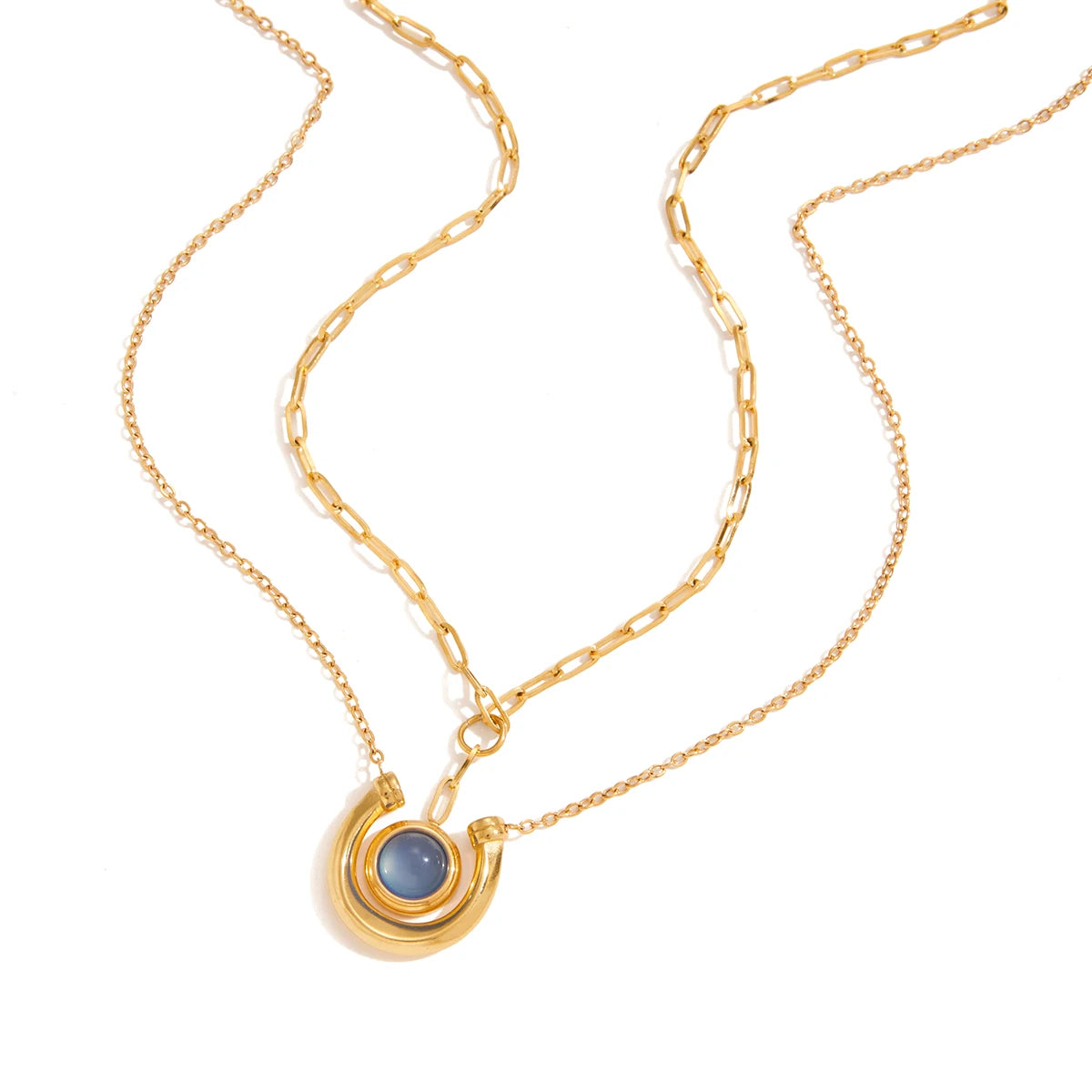 Horseshoe Gold necklace with a blue stone pendant on a white background