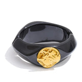 Wide resin bangle in dark red styled on wrist — statement bracelet by Ezra Gems