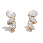 Gold earrings with clear gemstones on a white background