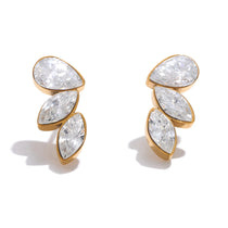 Gold earrings with clear gemstones on a white background