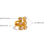 Gold ring with cubic zirconia stones on a white background