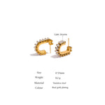 Gold hoop earrings with cubic zirconia on a white background
