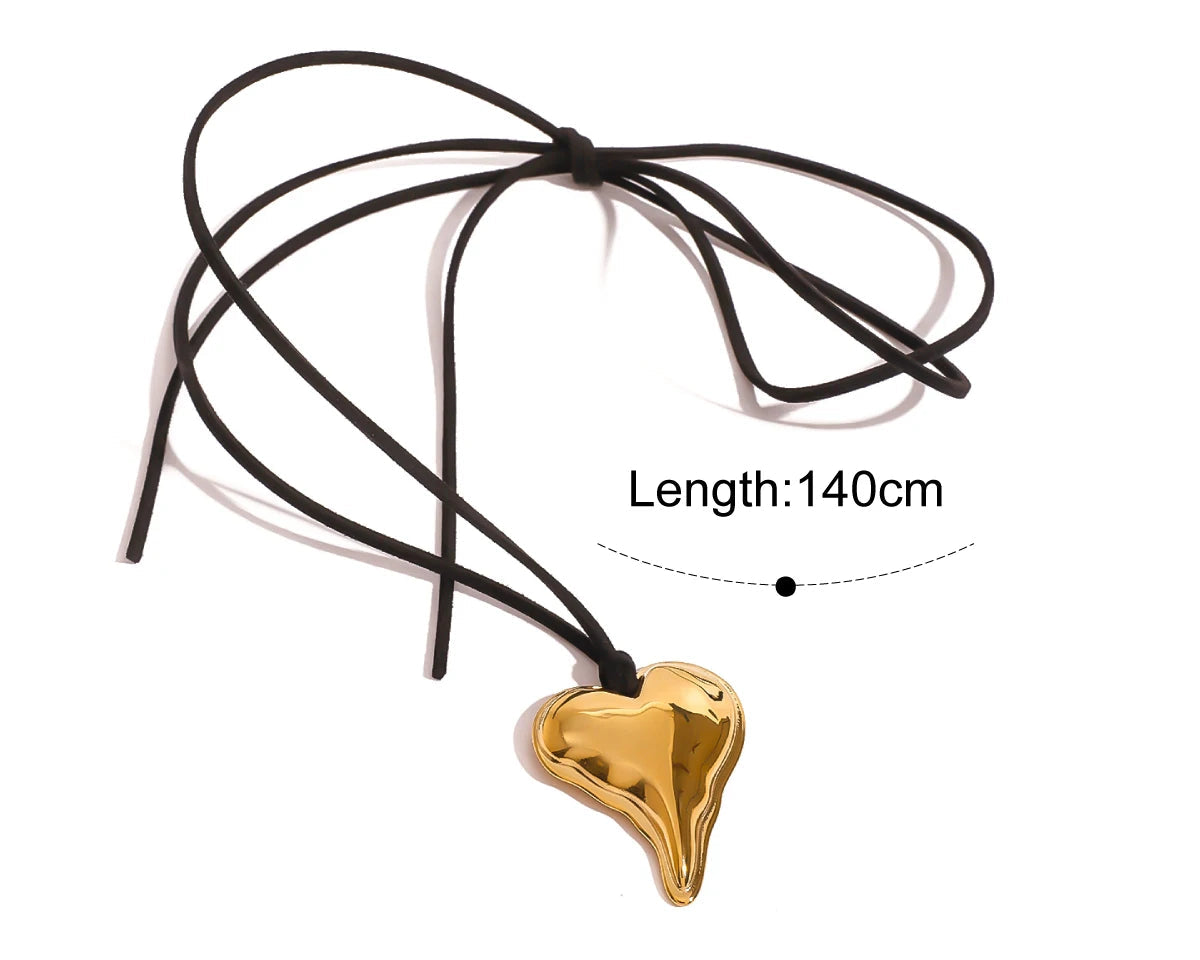 Gold heart-shaped pendant on a black cord with length measurement on a white background