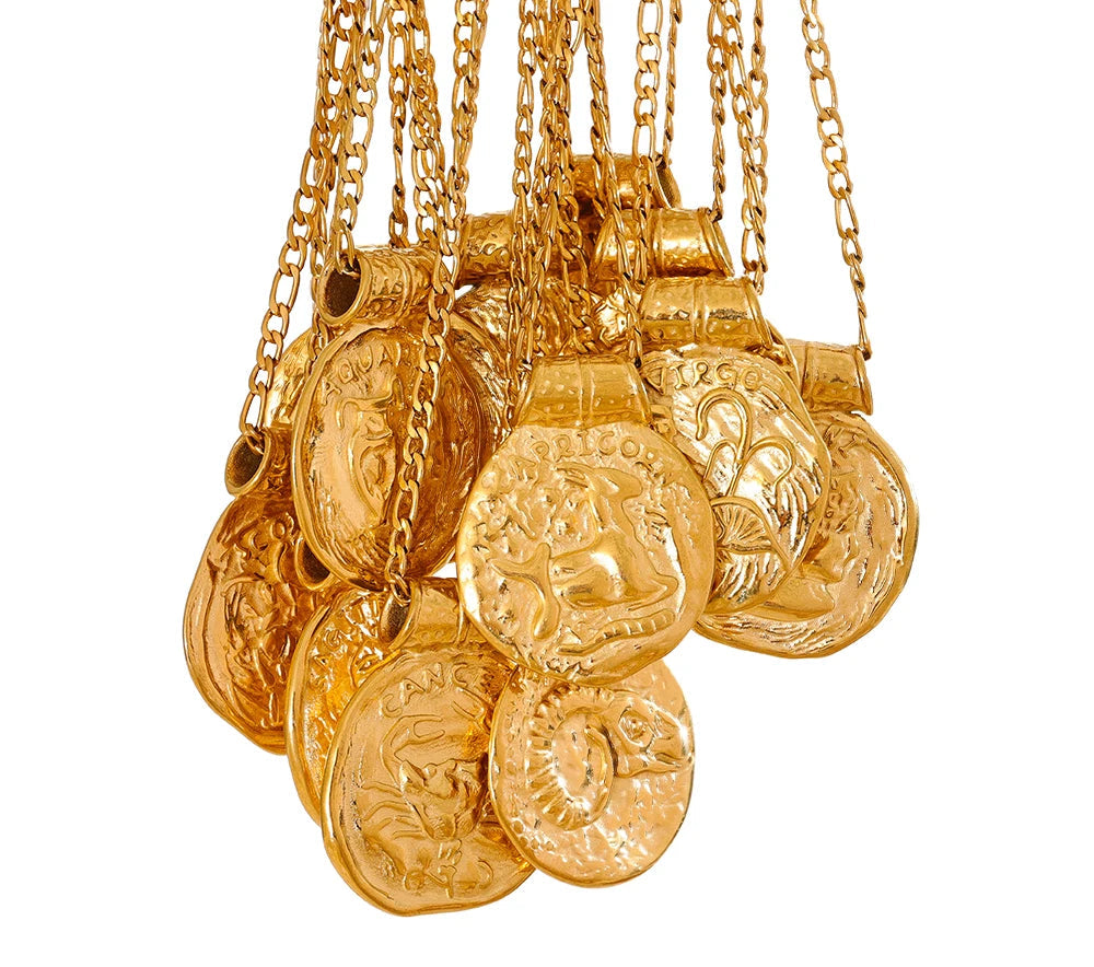 Gold coin zodiac vintage pendant necklaces with chains on a white background