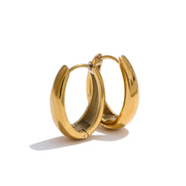 Gold hoop earrings on a white background