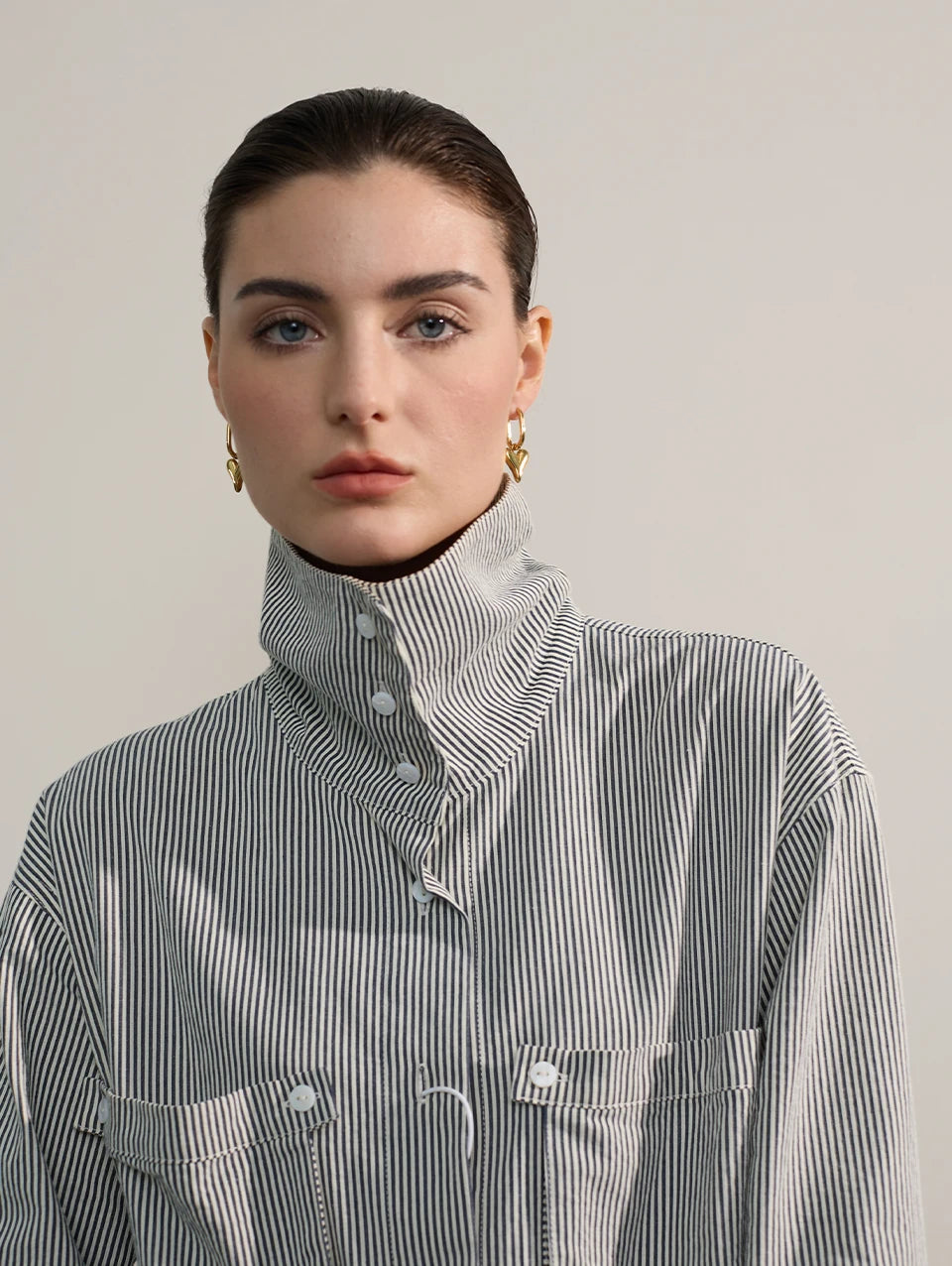 Stainless steel heart love drop hoop earrings with striped shirt display