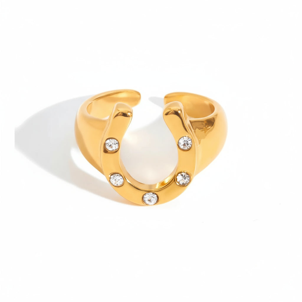 Gold ring with crystal stones and measurements on a white background