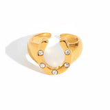 Gold ring with crystal stones and measurements on a white background
