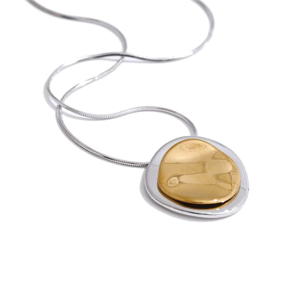 Gold and silver pendant necklace on a white background