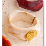 Multi-color resin wide bangle flat lay — 8 shades including orange, blue, and olive green