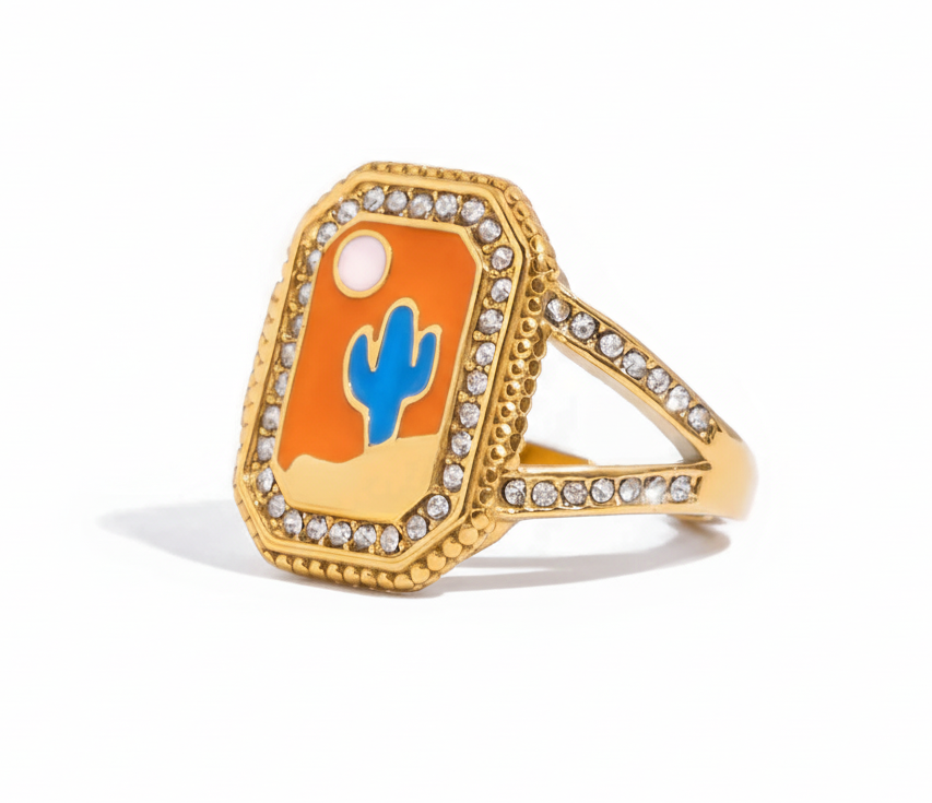 Gold ring with a blue cactus design on an orange background 
