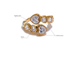 Gold ring with heart-shaped gemstones on a white background