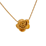 Gold rose-shaped pendant on a chain against a white background