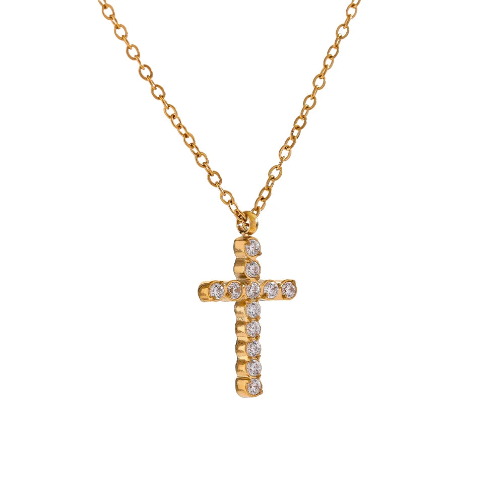 Gold cross necklace with diamonds on a white background
